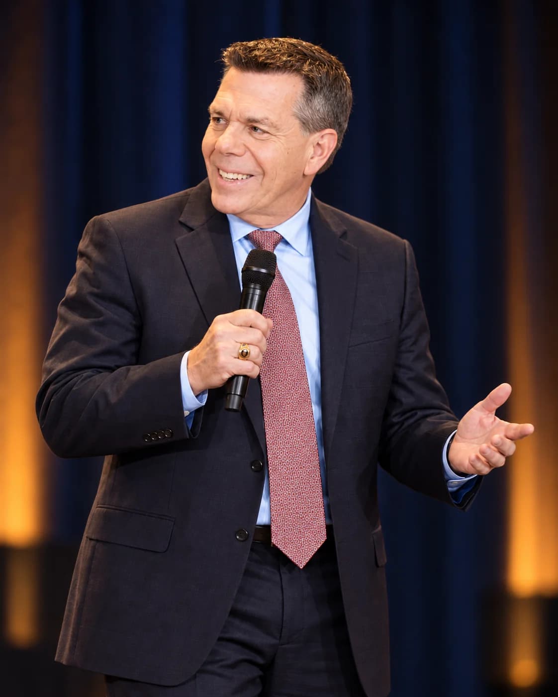 AI-generated illustration of Hugh Hornsby speaking on stage with a handheld microphone